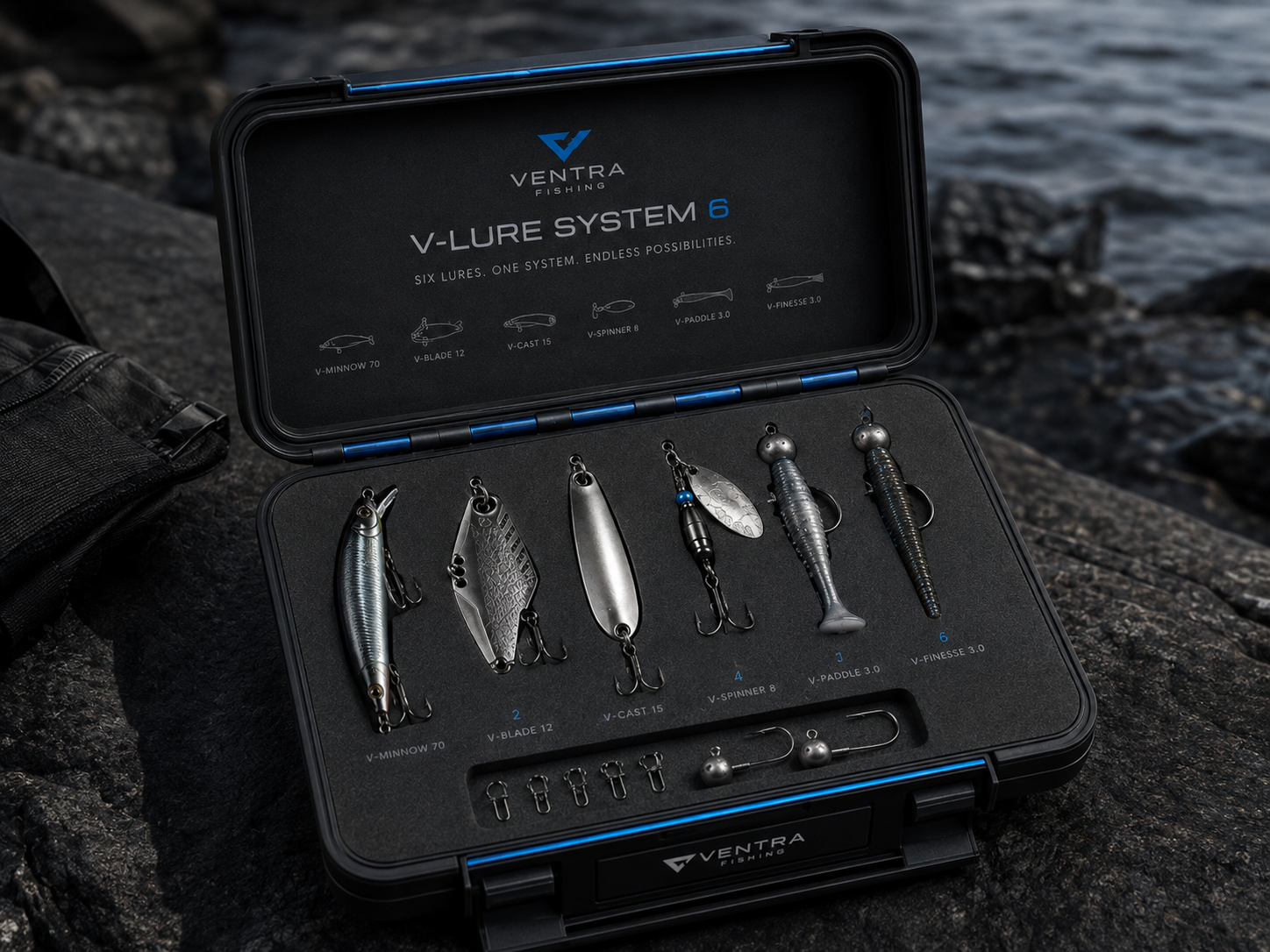 The V-Lure System 6 hard case open on wet rock beside the water, six lures and terminal tackle in the foam