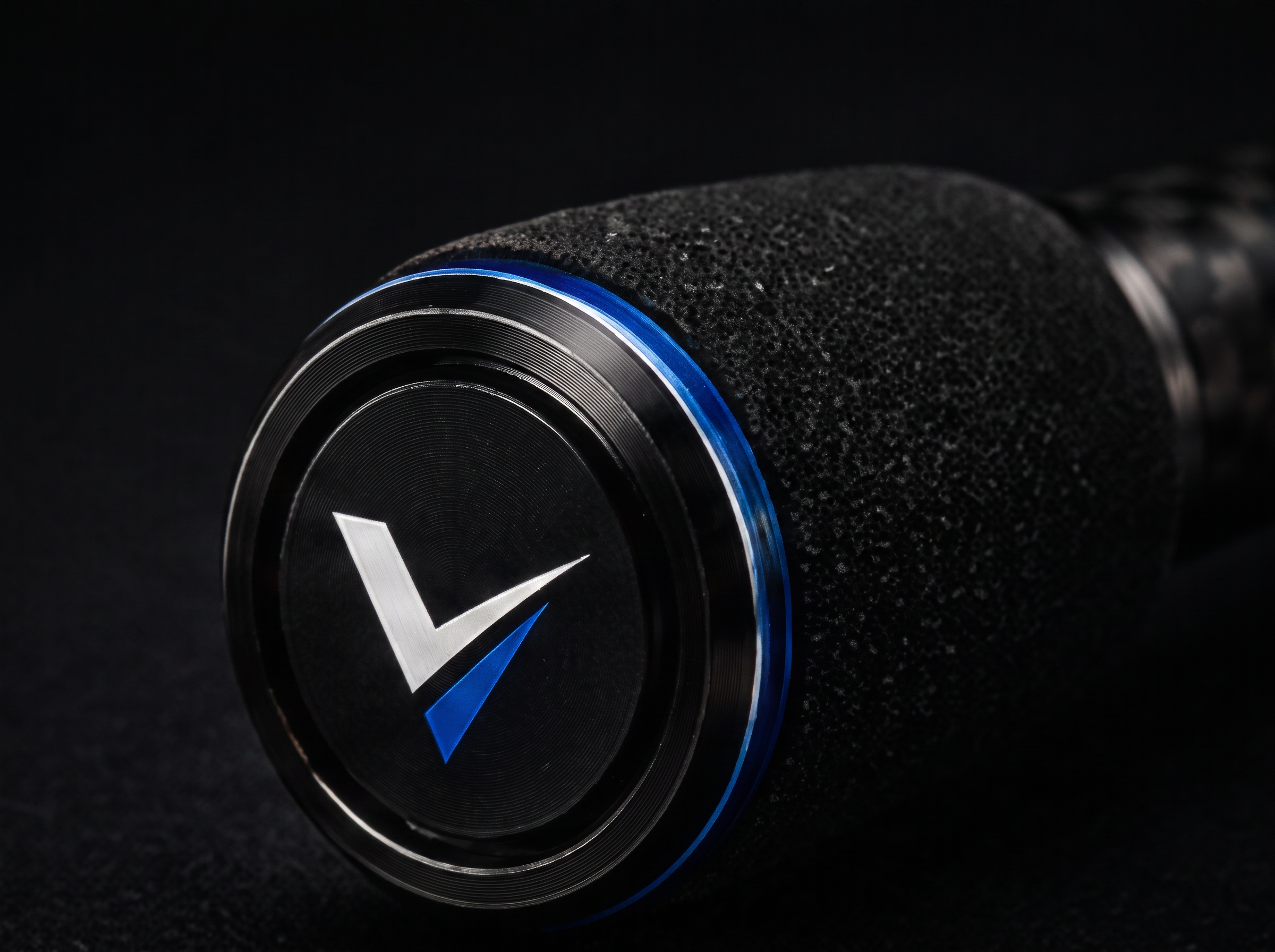 Machined butt cap closing the telescopic section stack, carrying the Ventra V mark