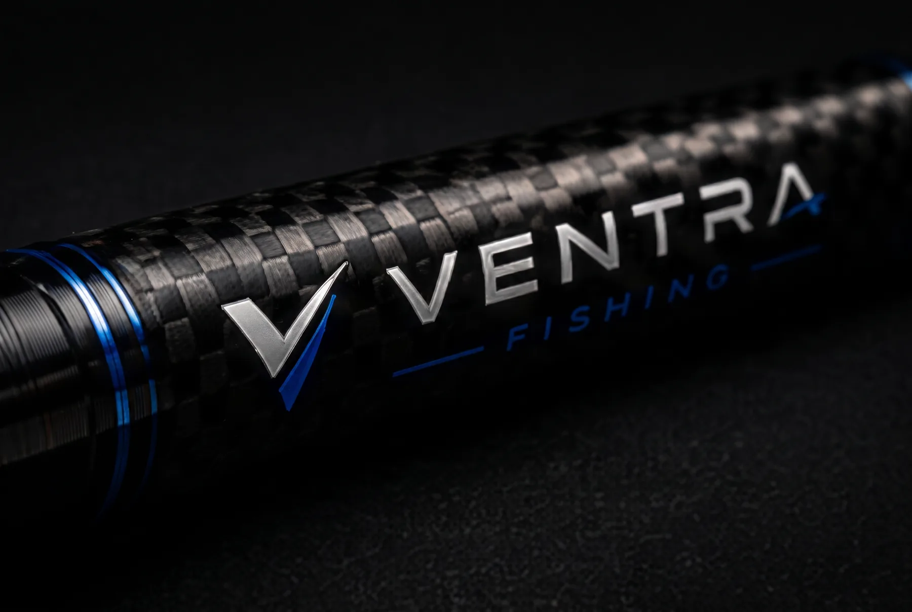 Macro detail of a telescopic carbon rod section carrying the Ventra Fishing mark