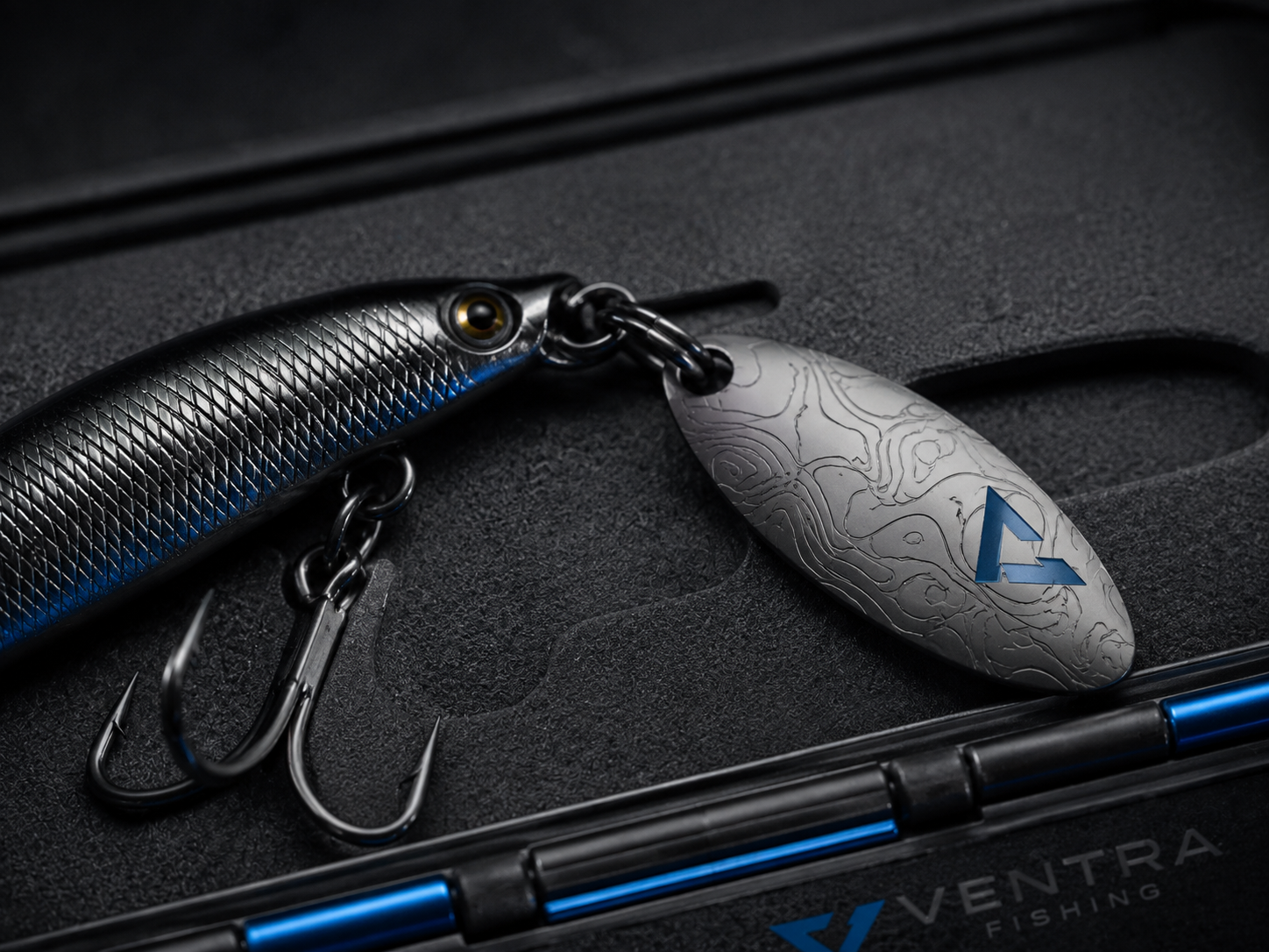 Macro detail of the V-Spinner 8 blade with etched contour pattern and blue Ventra Fishing mark