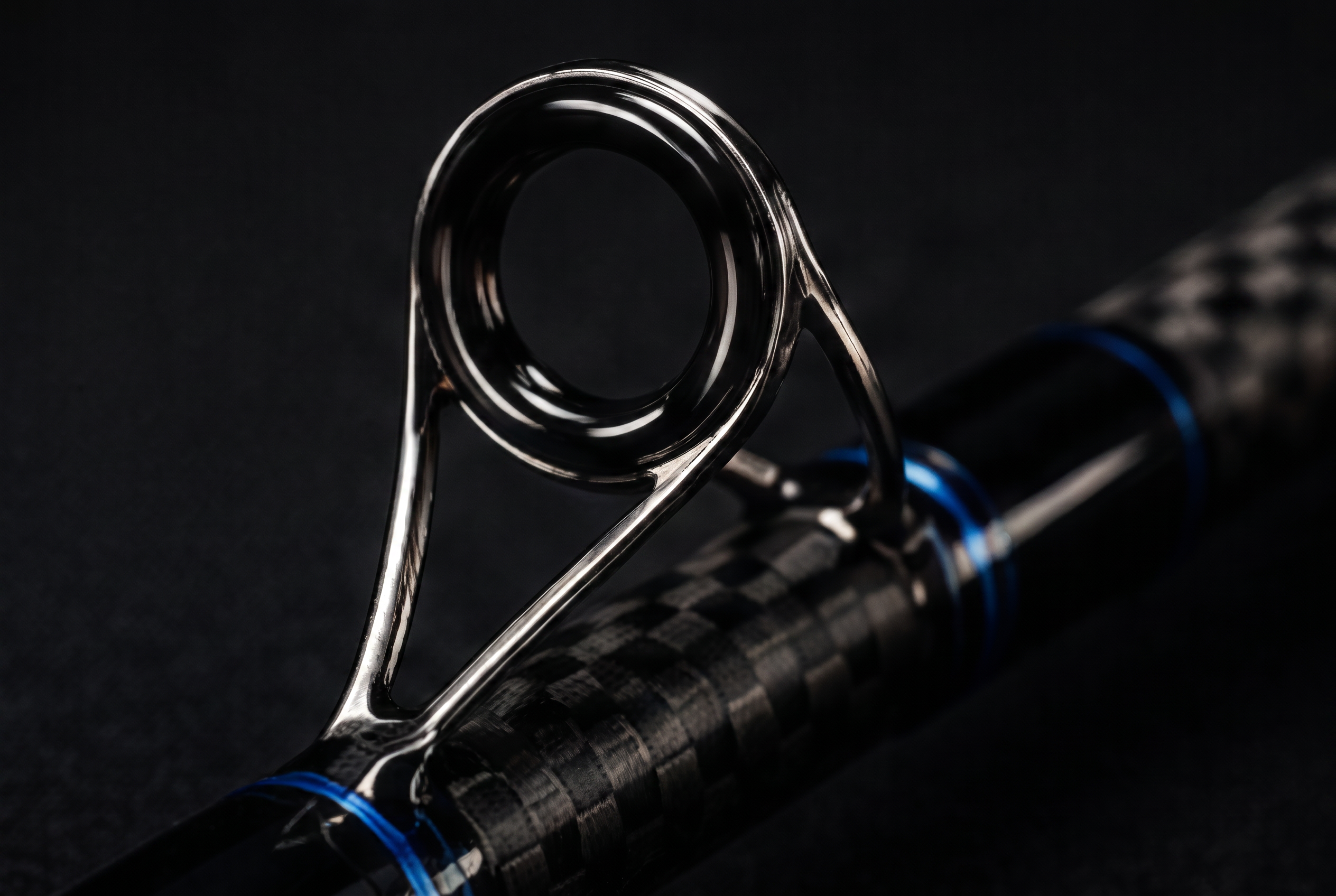 Close-up of a single hand-aligned guide bonded to a telescopic carbon section