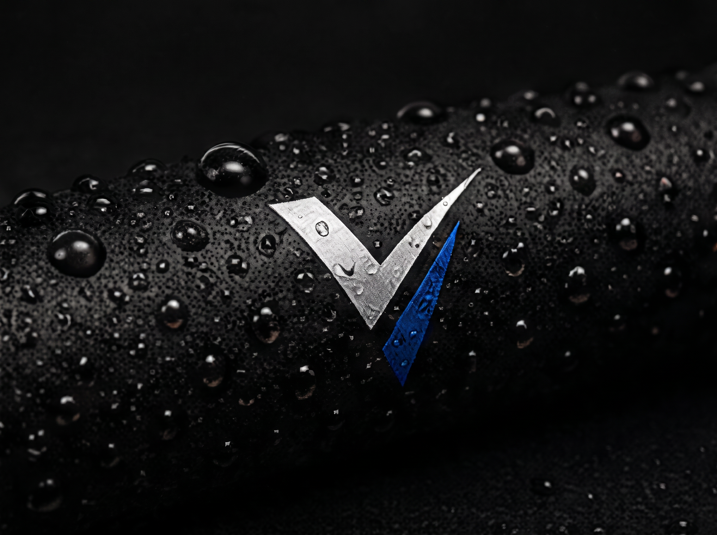 Water beading on a dark surface beside the Ventra V mark