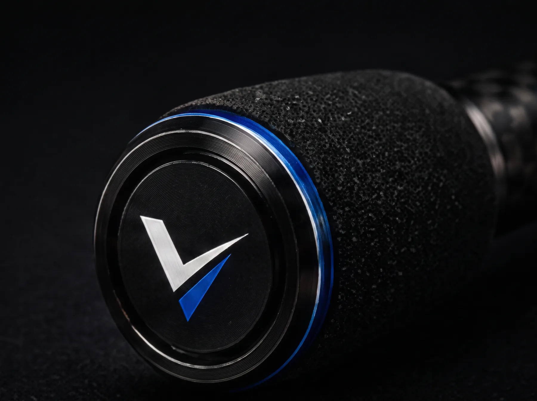 Machined butt cap closing the telescopic section stack, carrying the Ventra V mark
