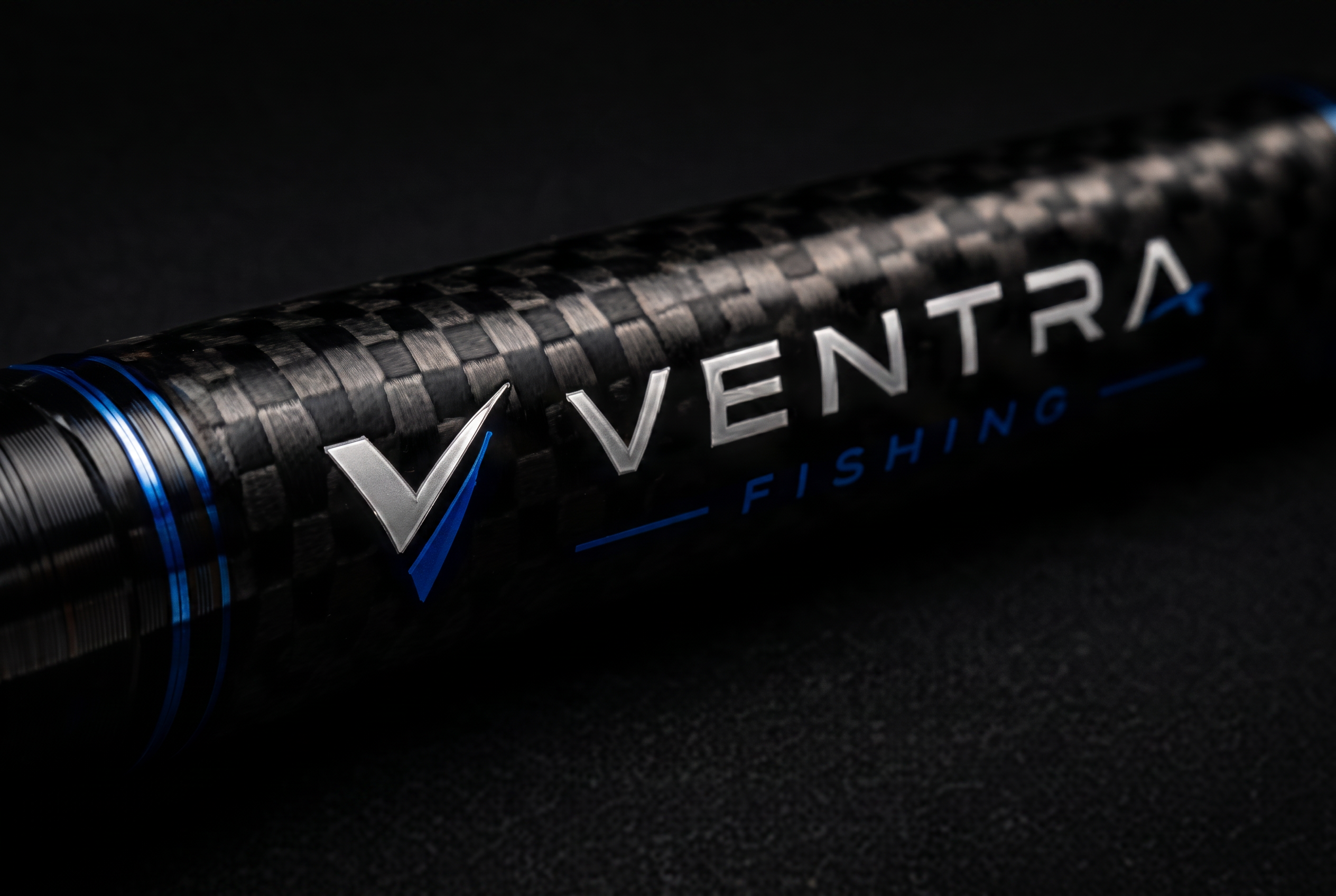 Macro detail of a telescopic carbon rod section carrying the Ventra Fishing mark
